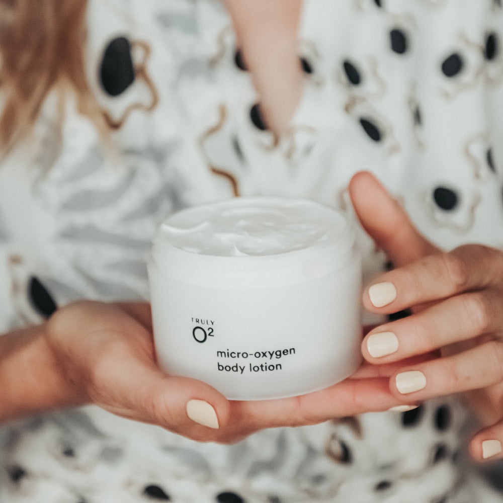 Woman's hands holding micro-oxygen body lotion jar